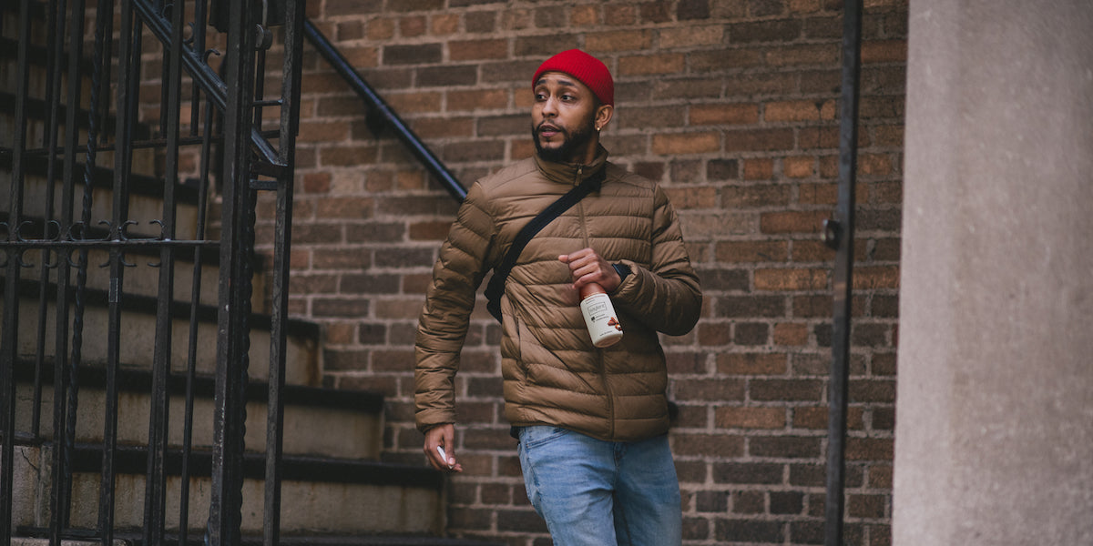 man holding protein shake