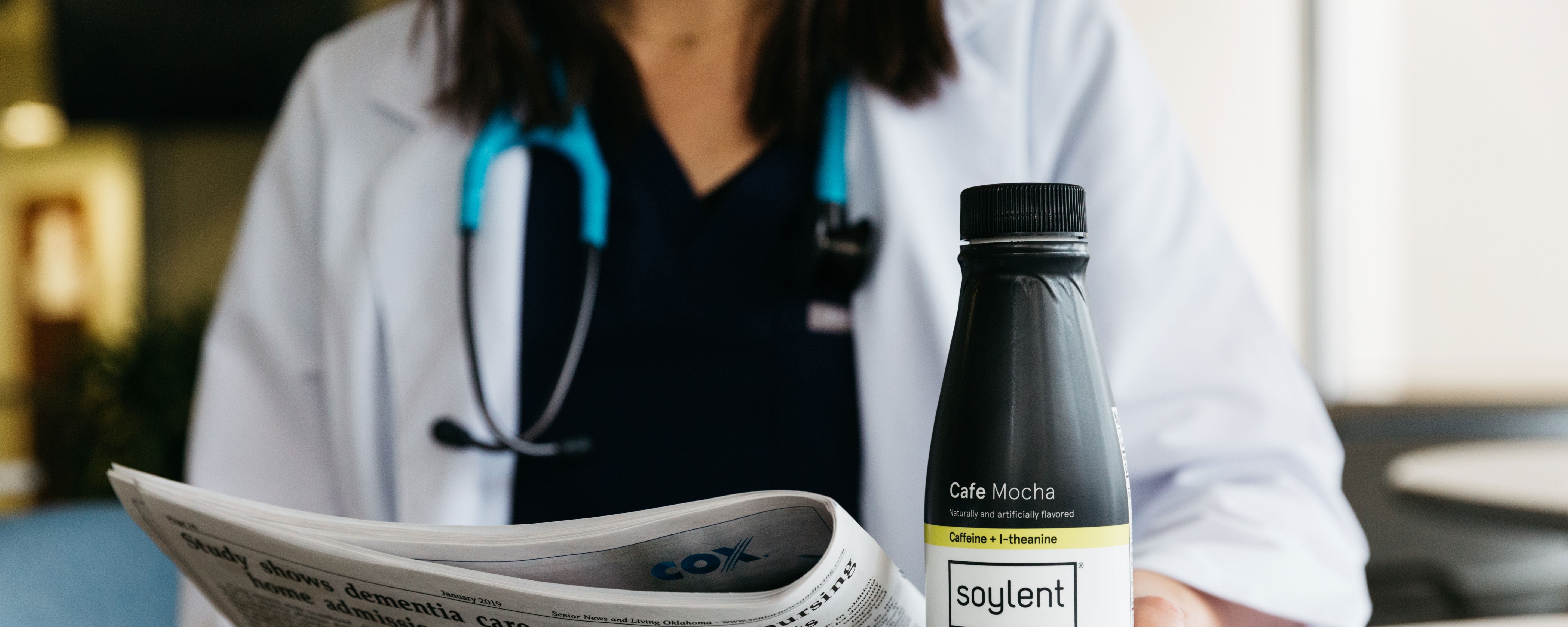 Doctor holding a bottle of Soylent